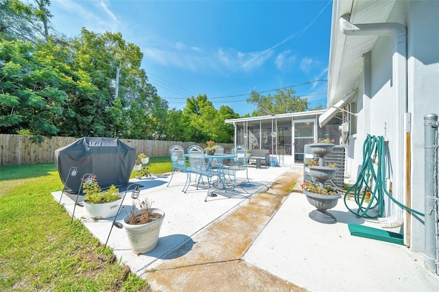 66 S Desoto St, Beverly Hills, FL 34465 - view of patio with a sunroom, area for grilling, and outdoor dining area