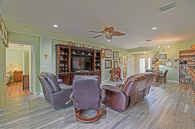 14004 SE 94th Ave, Summerfield, FL 34491 - living room with wood finished floors, a ceiling fan, a chandelier, baseboards, and recessed lighting