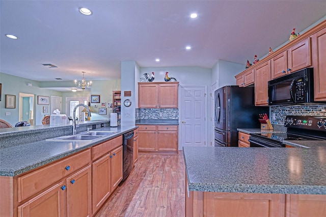 14004 SE 94th Ave, Summerfield, FL 34491 - kitchen featuring black appliances, a sink, dark countertops, backsplash, and a chandelier