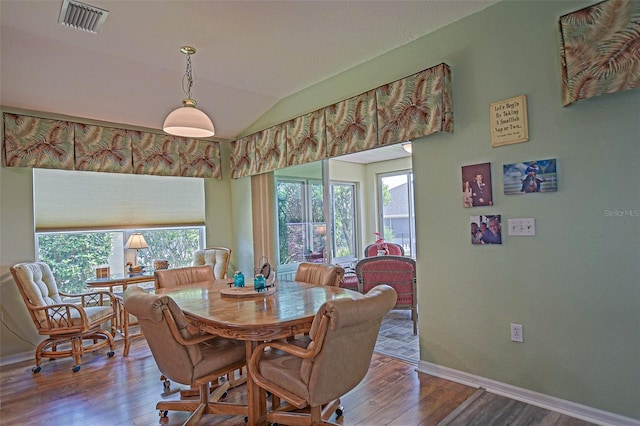 14004 SE 94th Ave, Summerfield, FL 34491 - dining area with wood finished floors, baseboards, and lofted ceiling