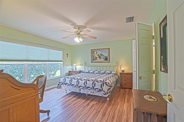 14004 SE 94th Ave, Summerfield, FL 34491 - bedroom featuring wood finished floors, baseboards, and a ceiling fan