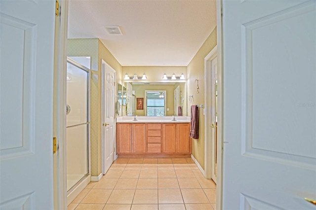 14004 SE 94th Ave, Summerfield, FL 34491 - full bath with tile patterned flooring, a stall shower, double vanity, and baseboards
