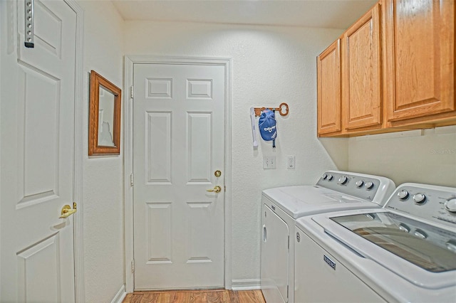 14004 SE 94th Ave, Summerfield, FL 34491 - laundry area featuring washing machine and dryer, cabinet space, light wood-style flooring, and baseboards
