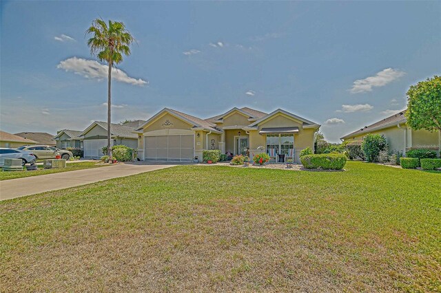 14004 SE 94th Ave, Summerfield, FL 34491 - ranch-style house featuring an attached garage, a front yard, driveway, and stucco siding