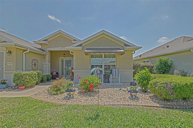 14004 SE 94th Ave, Summerfield, FL 34491 - view of front facade with stucco siding and a front lawn
