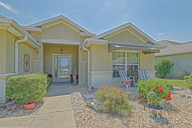 14004 SE 94th Ave, Summerfield, FL 34491 - doorway to property with stucco siding