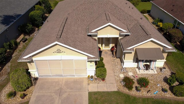 14004 SE 94th Ave, Summerfield, FL 34491 - view of front of home with driveway, an attached garage, and a shingled roof