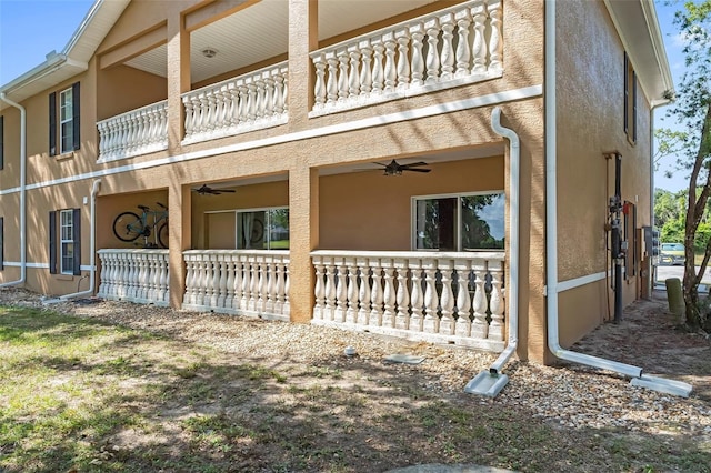 4450 E Windmill Dr Unit 101, Inverness, FL 34453 - view of side of home with a balcony, a ceiling fan, and stucco siding