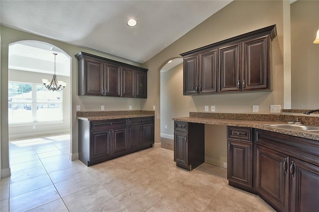 28 Malauka Pass Crse, Ocklawaha, FL 32179 - kitchen featuring arched walkways, dark brown cabinetry, a sink, vaulted ceiling, and a chandelier