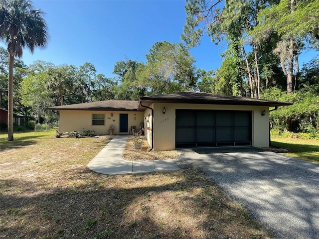 9740 W Cranberry St, Crystal River, FL 34428 - view of front of house with stucco siding, an attached garage, and a front yard