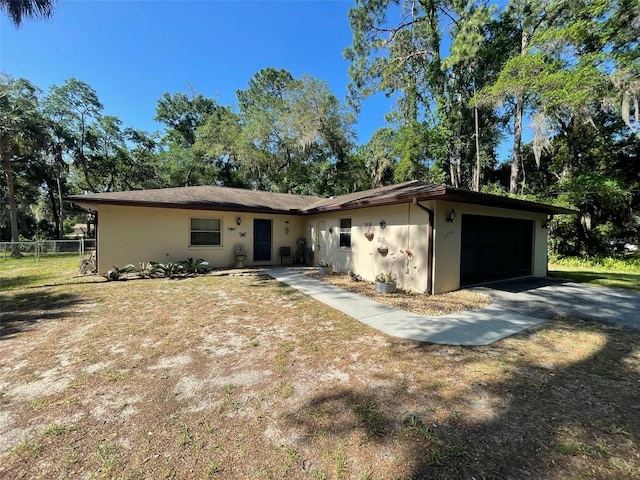 9740 W Cranberry St, Crystal River, FL 34428 - view of front of home with a garage, stucco siding, and driveway