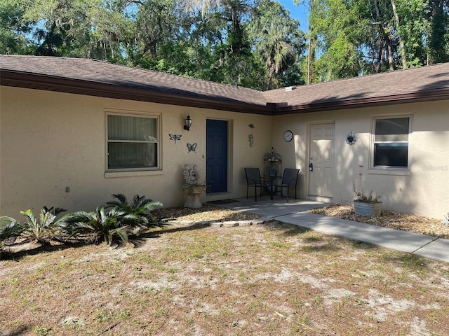 9740 W Cranberry St, Crystal River, FL 34428 - entrance to property with stucco siding and a shingled roof