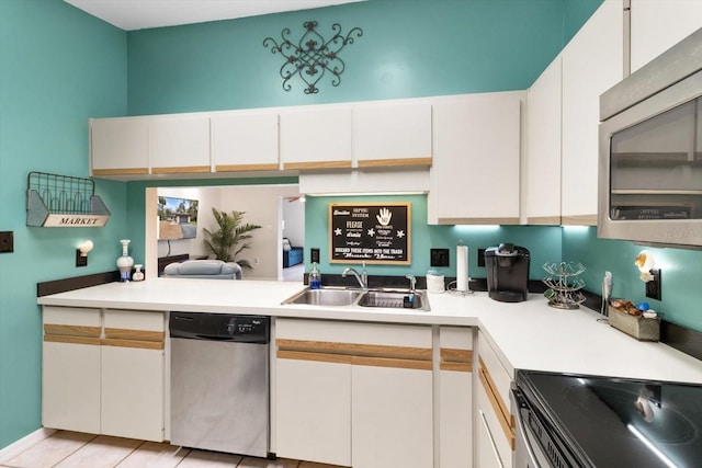 9740 W Cranberry St, Crystal River, FL 34428 - kitchen with stainless steel appliances, a sink, light countertops, and white cabinets