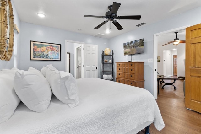 9740 W Cranberry St, Crystal River, FL 34428 - bedroom featuring wood finished floors, a ceiling fan, and connected bathroom