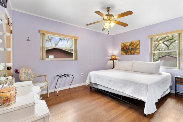9740 W Cranberry St, Crystal River, FL 34428 - bedroom featuring multiple windows, wood finished floors, baseboards, ornamental molding, and a ceiling fan