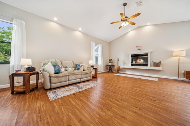 451 E Ireland Ct, Hernando, FL 34442 - living area featuring wood finished floors, healthy amount of natural light, vaulted ceiling, a ceiling fan, and baseboards