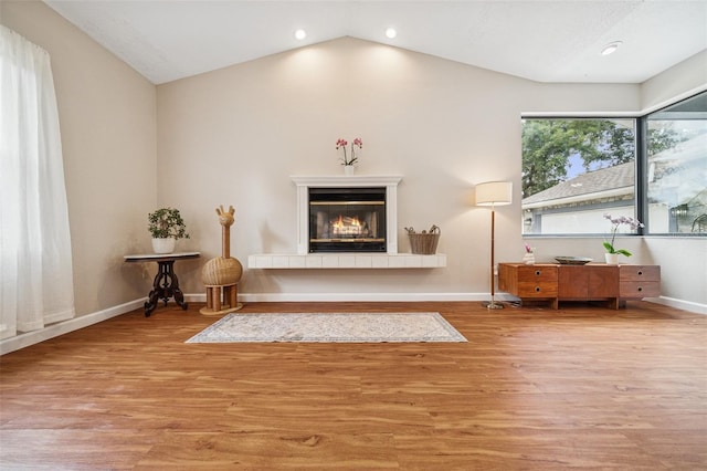 451 E Ireland Ct, Hernando, FL 34442 - living room with a tiled fireplace, lofted ceiling, wood finished floors, baseboards, and recessed lighting