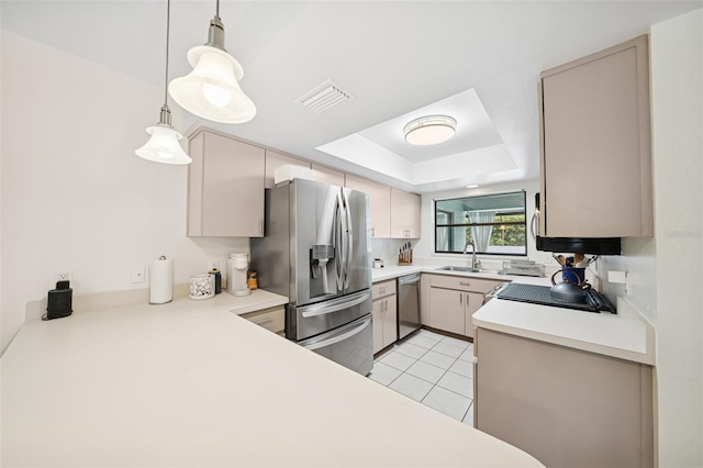 451 E Ireland Ct, Hernando, FL 34442 - kitchen with stainless steel appliances, a raised ceiling, light tile patterned floors, a sink, and light countertops