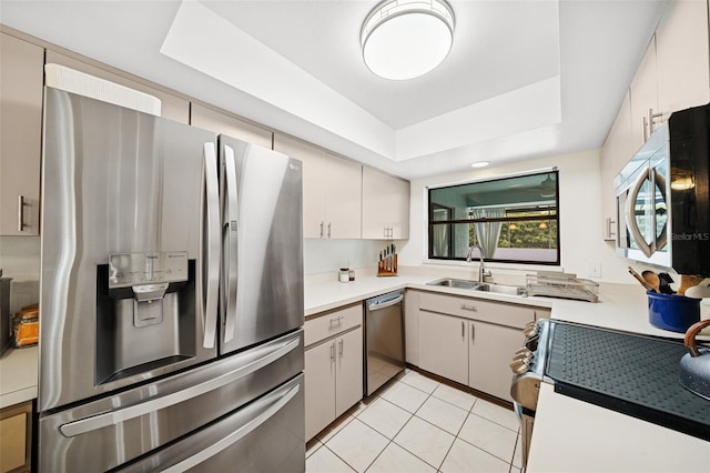 451 E Ireland Ct, Hernando, FL 34442 - kitchen with appliances with stainless steel finishes, a sink, a raised ceiling, light tile patterned floors, and light countertops