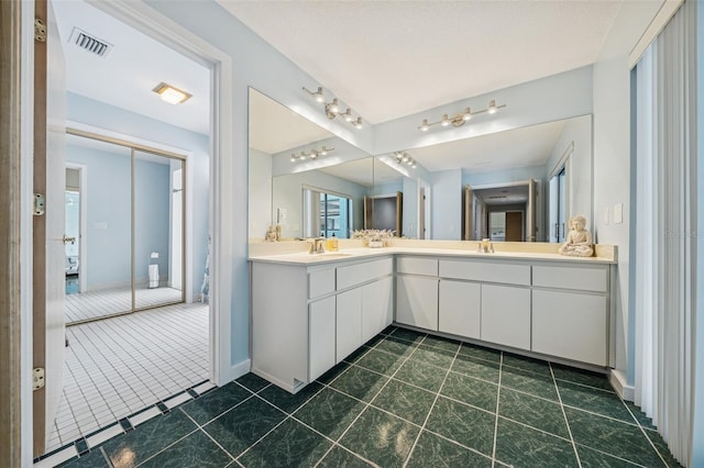 451 E Ireland Ct, Hernando, FL 34442 - bathroom with double vanity, baseboards, and tile patterned floors