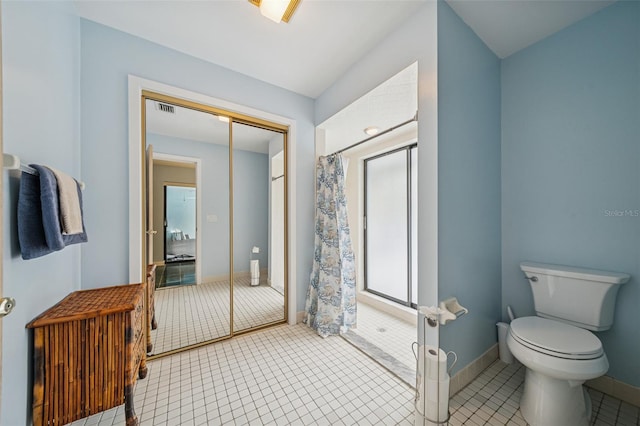 451 E Ireland Ct, Hernando, FL 34442 - bathroom with toilet, a shower with shower curtain, baseboards, and tile patterned floors