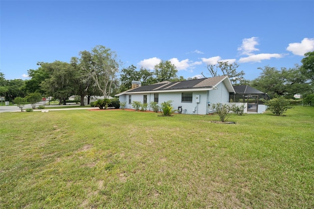 451 E Ireland Ct, Hernando, FL 34442 - view of side of property featuring a lawn, a chimney, and stucco siding