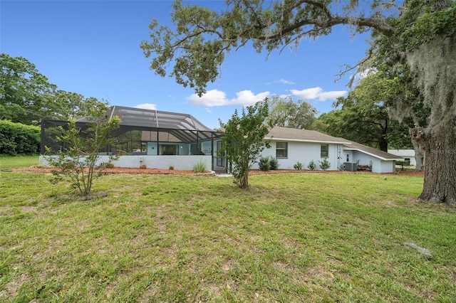 451 E Ireland Ct, Hernando, FL 34442 - back of house featuring a yard, cooling unit, glass enclosure, and a carport