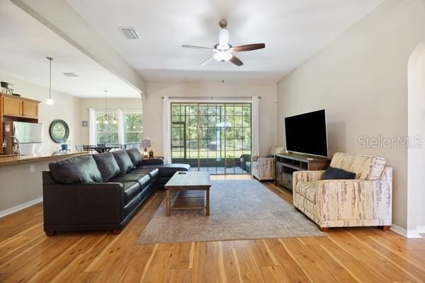 6235 SW 95th Pl, Ocala, FL 34476 - living room featuring ceiling fan, light wood finished floors, and baseboards