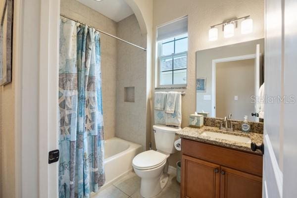 6235 SW 95th Pl, Ocala, FL 34476 - full bathroom featuring tile patterned flooring, toilet, shower / tub combo with curtain, and vanity