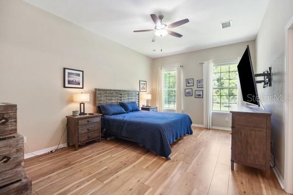 6235 SW 95th Pl, Ocala, FL 34476 - bedroom featuring light wood finished floors, baseboards, and ceiling fan
