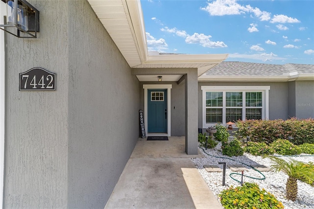 7442 SW 129th Ln, Ocala, FL 34473 - property entrance with stucco siding and a shingled roof