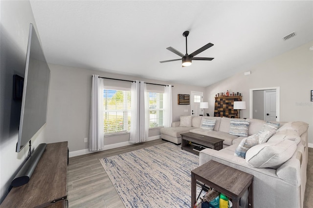 7442 SW 129th Ln, Ocala, FL 34473 - living room featuring ceiling fan, light wood finished floors, vaulted ceiling, and baseboards