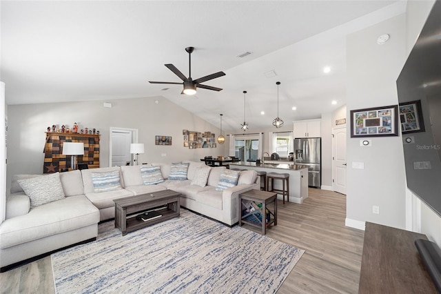 7442 SW 129th Ln, Ocala, FL 34473 - living area featuring vaulted ceiling, a ceiling fan, light wood-style floors, recessed lighting, and baseboards