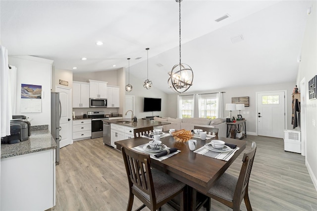 7442 SW 129th Ln, Ocala, FL 34473 - dining space featuring a chandelier, light wood-type flooring, high vaulted ceiling, baseboards, and recessed lighting