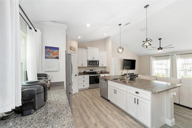 7442 SW 129th Ln, Ocala, FL 34473 - kitchen with appliances with stainless steel finishes, a sink, open floor plan, ceiling fan, and light wood-style floors