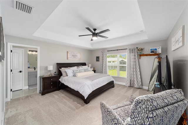 7442 SW 129th Ln, Ocala, FL 34473 - bedroom with a tray ceiling, baseboards, light carpet, and ceiling fan
