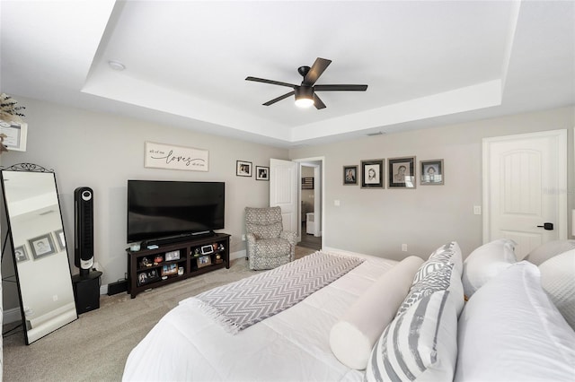 7442 SW 129th Ln, Ocala, FL 34473 - bedroom featuring a tray ceiling, light carpet, baseboards, and ceiling fan