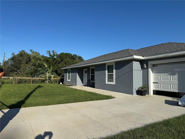 1100 NW 126th Ln, Citra, FL 32113 - back of property with an attached garage, concrete driveway, a yard, and roof with shingles