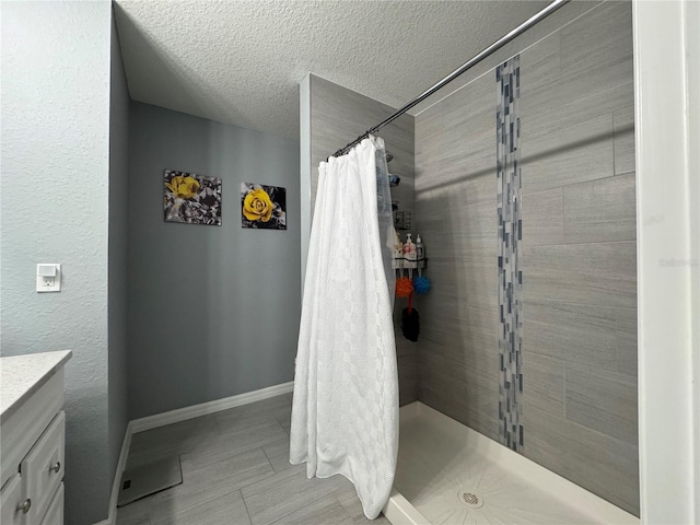 1100 NW 126th Ln, Citra, FL 32113 - full bathroom with vanity, a shower stall, baseboards, and a textured ceiling