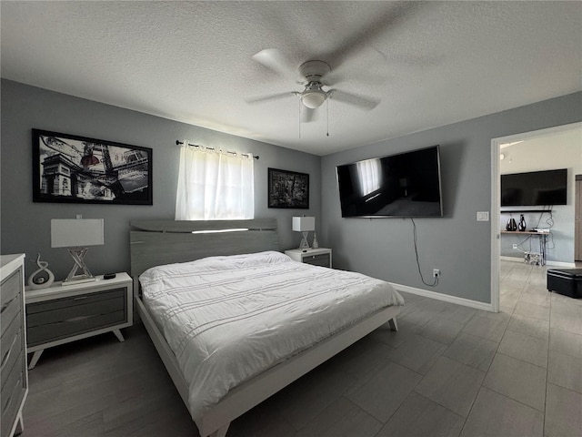 1100 NW 126th Ln, Citra, FL 32113 - bedroom featuring baseboards, a textured ceiling, and a ceiling fan
