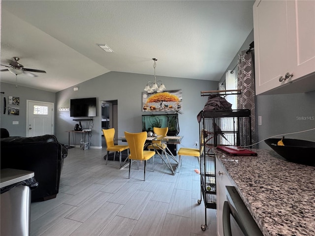 1100 NW 126th Ln, Citra, FL 32113 - dining area with lofted ceiling, a ceiling fan, a chandelier, light wood-style floors, and baseboards