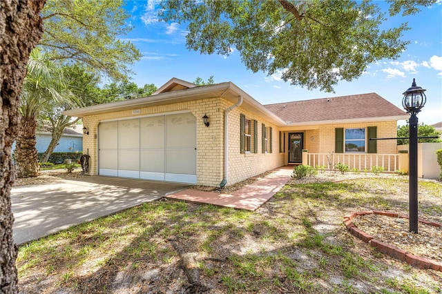 9266 SW 91st Cir, Ocala, FL 34481 - ranch-style house with brick siding, an attached garage, and driveway