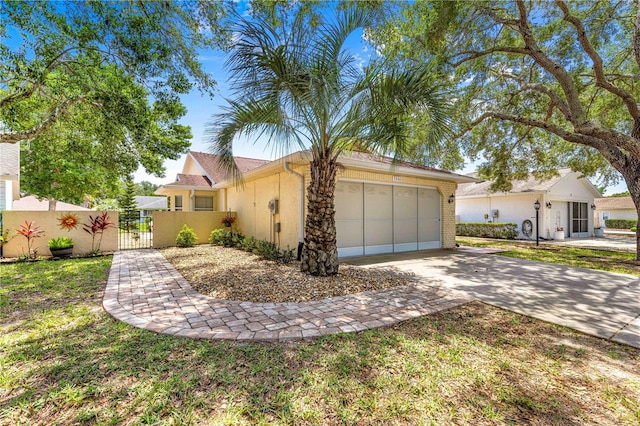 9266 SW 91st Cir, Ocala, FL 34481 - view of front of house featuring a gate, driveway, an attached garage, and stucco siding