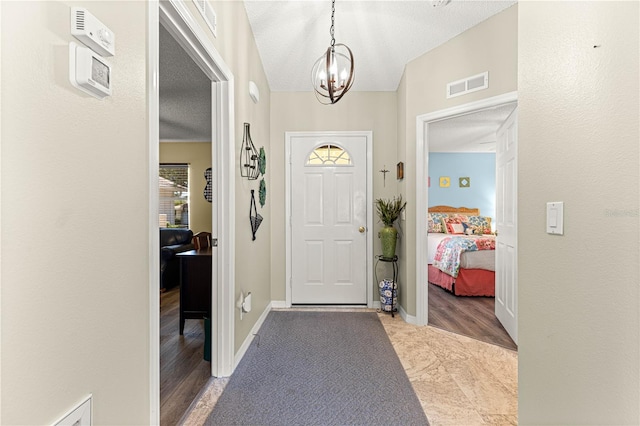 9266 SW 91st Cir, Ocala, FL 34481 - entrance foyer featuring a chandelier, a textured ceiling, and baseboards