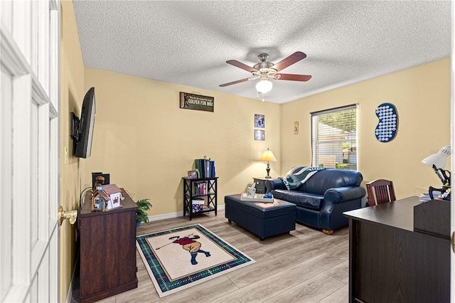 9266 SW 91st Cir, Ocala, FL 34481 - living room featuring ceiling fan, light wood finished floors, a textured ceiling, and baseboards