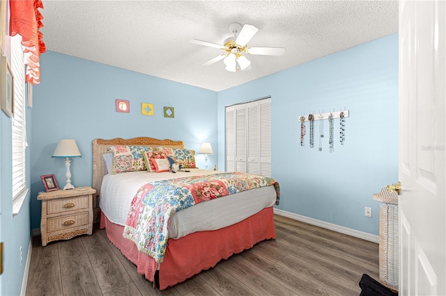 9266 SW 91st Cir, Ocala, FL 34481 - bedroom with wood finished floors, a closet, a textured ceiling, baseboards, and ceiling fan