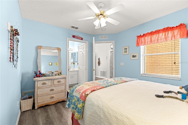 9266 SW 91st Cir, Ocala, FL 34481 - bedroom featuring wood finished floors, a textured ceiling, baseboards, a ceiling fan, and ensuite bath