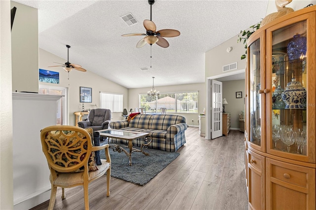9266 SW 91st Cir, Ocala, FL 34481 - living area with ceiling fan, a textured ceiling, light wood-style flooring, lofted ceiling, and a chandelier