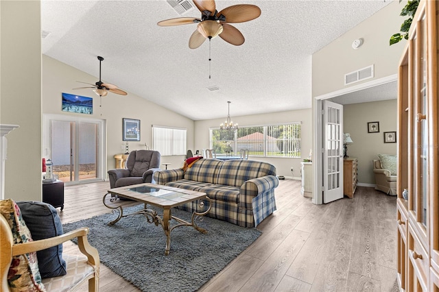9266 SW 91st Cir, Ocala, FL 34481 - living area with ceiling fan, a textured ceiling, light wood-style flooring, a chandelier, and french doors