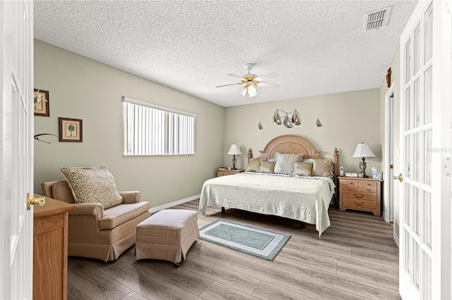 9266 SW 91st Cir, Ocala, FL 34481 - bedroom featuring light wood-style flooring, a textured ceiling, and ceiling fan